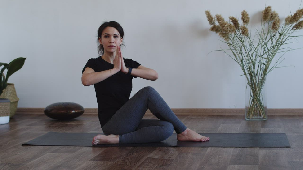 Woman doing a seated stretch at home