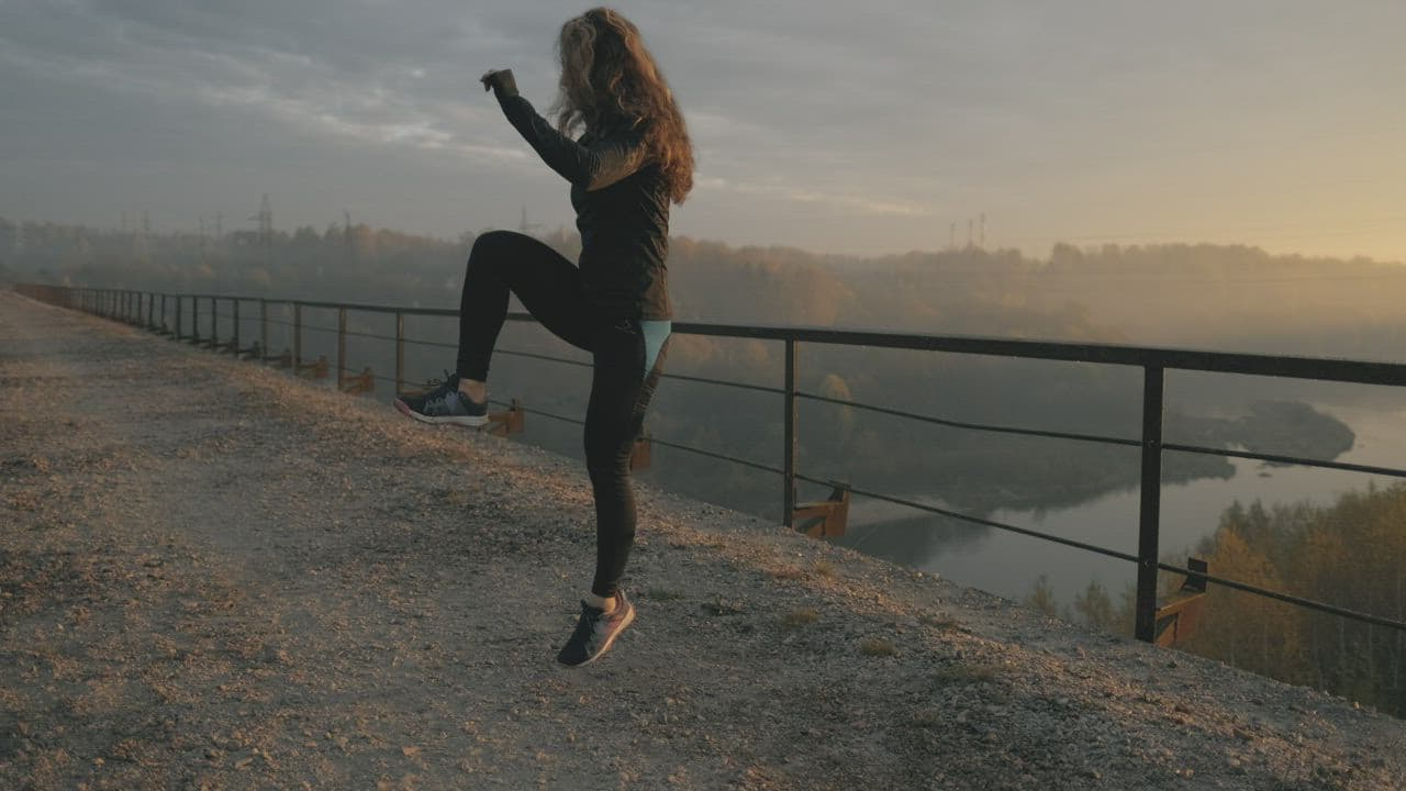 Woman training outdoors at sunrise