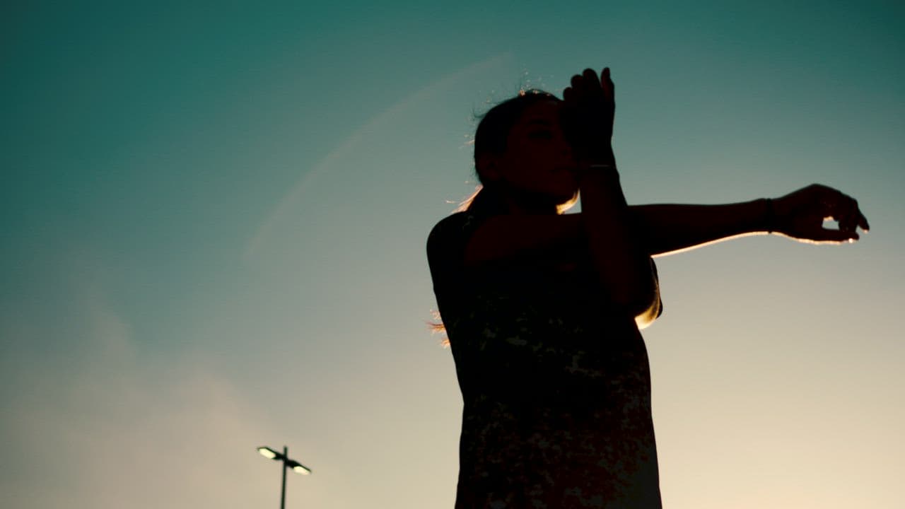 Silhouette of a woman stretching at sunset